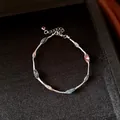 Close-up of rainbow beads inside silver mesh cage on a minimalist chain necklace. - Multicolor