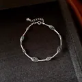 Detail view of a silver-toned mesh bracelet with elegant green candy-colored beads inside. - Bracelet-Green