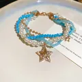 Macro view of a multi-layer necklace and bracelet set with star charms and blue beads - 83# Star Charm Multi-layer Wrap Style / Gold Blue White