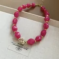Detail of fuchsia twisted acrylic beads and gold-toned irregular accent bead on a necklace - Twisted Bead Fashion Choker (60#) / Gold + Rose Red (60#)