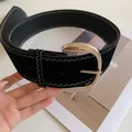 Close-up of wide black belt with white zig-zag stitching and silver metal buckle - Black Belt