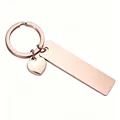 Close-up of rose gold stainless steel bar and heart charm keychain with mirror finish - Rose Gold