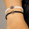 Detailed macro view of adjustable braided Halloween spider and web charm bracelets on a wrist - Spider and Spider Web Combo Set / Two-Piece Set / Black and White