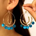 Bohemian vintage gold-tone double teardrop earrings featuring vibrant blue shell dangles. - Double Teardrop Shell Style (11867) / KC Gold Blue