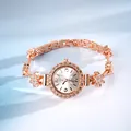 Close-up of rose gold bracelet watch with rhinestone flower charms and elegant dial - Flower Rhinestone Bracelet Watch / Rose Gold