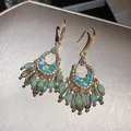 Close-up detail of green teardrop earrings with bohemian fringe and gold hook finish - Bohemian Hollow Tassel Style (70#) / Hook Style / Gold-Green