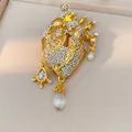 Detailed view of a gold anatomical heart brooch adorned with rhinestones and pearls - Gold Style (HP1030)