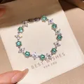 Elegantes Silberarmband mit funkelnden grünen Zirkonia und hübschen Blumenmotiven - Seeblauer Sechseck-Blumenstil (52#)