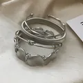 Elegante set di bracciali in metallo pesante argentato con finitura strutturata - Set di Bracciali Rigidi con Texture Multiple (70#) / Set da 4 pezzi / Argento