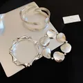 Set di tre bracciali statement color argento con design metallici artistici e unici - Set di Bracciali in Metallo Pesante Argento (78#) / Set da 3 pezzi / Argento