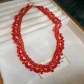 Close-up of an intricate red and gold crystal beaded lace choker in a jewelry box - Necklace (HN11516) / Red