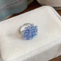 Detail view of a sweet blue glass beaded ring placed on a white velvet jewelry box - Ring / Blue