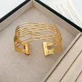 Detailed close-up of gold multi-layered hollow wire cuff bracelet in a jewelry box - Multi-layer Line Open Style / 52# Gold Keyhole Bangle