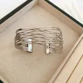 Close-up detail of a silver-finish minimalist multi-layer intertwined wire cuff bracelet - Multi-layer Fine Line Cross Open Style / 53# Silver Keyhole Bangle