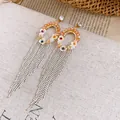 Close-up of elegant hollow round earrings with long silver bead tassels and orange beads - Streaming Flower Tassel (31# 925 Sterling Silver Earring Post-Gold) / Coffee-White