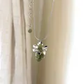Close-up of a grape-shaped pendant necklace featuring light green polished stone beads - Green Grape Cluster Necklace