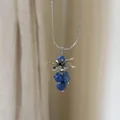 Detailed view of an elegant silver grape pendant necklace with blue stone beads - Blue Stone Cluster Necklace