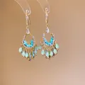 Close-up detail of ethnic style teardrop earrings with crystals and blue bead charms - Streaming Flower Tassel (57# Earring Hook-Gold) / Green