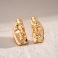 Detailed view of polished golden abstract human face mask metallic stud earrings - Silver Post Face Mask Stud Earrings / Gold