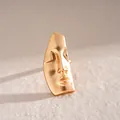 Detailed view of artistic golden human face mask earring with smooth metallic finish. - Matte Face Mask Ring / Gold