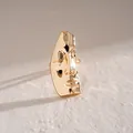 Detailed view of an abstract gold face mask ring with a smooth metallic finish - Polished Face Mask Ring / Gold