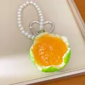 Close-up detail of realistic orange fruit keychain with pearl beads and heart-shaped clip - Green Tangerine Peeled Charm (Silver Clasp) / Green/Orange