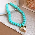 Detail view of turquoise resin beads and a polished gold heart pendant necklace. - Heart Pendant Beaded Necklace (56#) / Gold + Cyan (56#)
