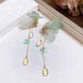 Close-up of butterfly drop earrings with iridescent teardrop charms and green fabric wings - Butterfly Tassel Long Style (18#) / Silver / Green