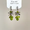 Detailed view of vintage-style flower earrings with silver petals and green beads. - Style 7 / Silver Earring Post - Silver - Green