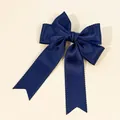 Detailed view of a navy blue ribbon hair bow with scalloped edges and elegant long streamers - Navy Blue