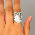Close-up of retro silver corset shaped ring with intricate lace textures and bows. - Corset Style(A-1214) / Silver