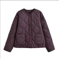 Detailed front view of a stylish purple quilted jacket featuring a round neck and pockets. - XS / Coffee