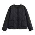 Detailed view of a black quilted jacket featuring a round neck and button closure. - Black / XS