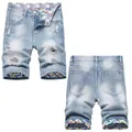 Men's ripped denim shorts in light blue with distressed details and graffiti lining. - EU 42 / Light Blue (665#)