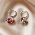 Vintage silver hoop earrings featuring colorful multi-gemstone bead charms on silk background - 2606176 Colorful Beaded Hoop Earrings