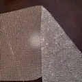 Close-up view of a sparkling silver rhinestone metal mesh fabric for a party top - One Size / Khaki