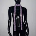 Close-up of a long purple sparkly rhinestone scarf necklace for music festivals on a mannequin - Purple