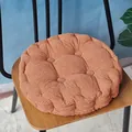 Thick round corduroy chair cushion in terracotta with tufted corn grain texture. - Coffee Round