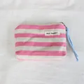 Detailed view of a pink and white striped canvas coin purse with MAY RABBIT label. - Pink Stripe