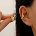 Elegant minimalist gold cat-shaped ear cuff for non-pierced ears shown on model - 18K Gold Tone - Sitting Cat Silhouette Style (Z-148)