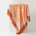 Elegant orange polka dot and paisley silk-like satin scarf draped on a stand. - Orange (K121)