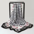Macro detail of retro paisley and polka dot printed satin scarf draped on frame - Black (K121)