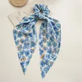 Elegant blue floral fabric scrunchie with long streamers for chic ponytail styling - Petal Blue Streamer