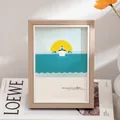 Minimalist wood texture picture frame featuring sea sunrise illustration on white desk - Light Coffee Wood Grain