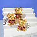 Set di tre portachiavi a forma di mucca dorata con caratteri cinesi portafortuna. - Bue Dorato 2