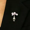 Elegant silver flower vase brooch pin with pink blossoms pinned on a black suit lapel - 18 Bright Silver 10739 (brooch Without Floral Design)