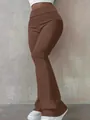 Detail view of brown high-waisted flared leggings with a comfortable wide waistband. - Brown