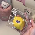 Realistic lemon-shaped squishy toy in clear packaging for stress relief - Fluid Yellow Lemon Soft Touch