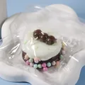 Cute cake-shaped silicone squishy stress reliever toy in a clear plastic zip bag - Chocolate Soy Milk Squishy