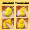 Yellow banana-shaped silicone squishy toy for stress relief being squeezed by hand - Food Squishy (Banana Yellow)